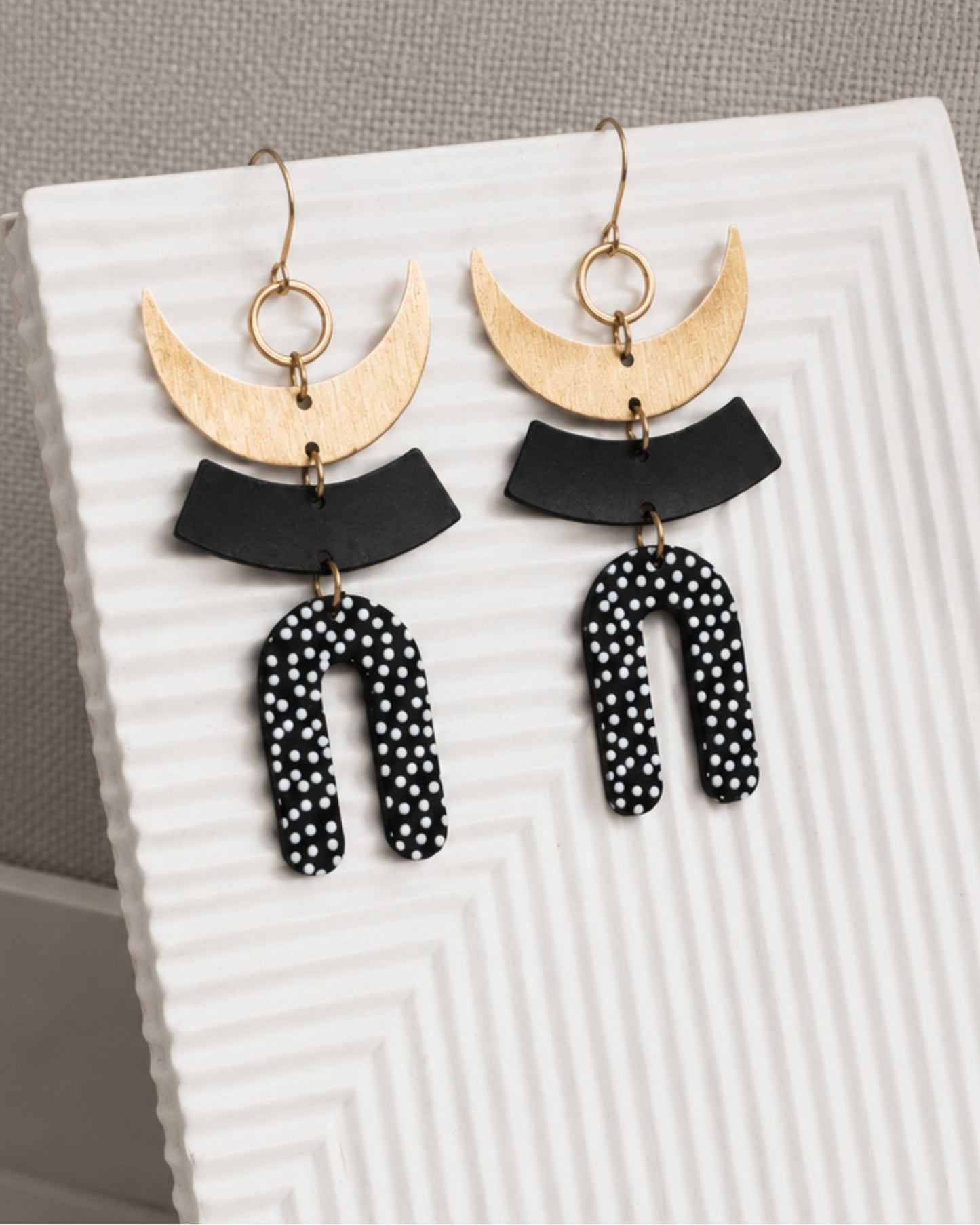 Close-up detail of The Liv black-and-white polka dot and gold statement earrings — Olivia Holland