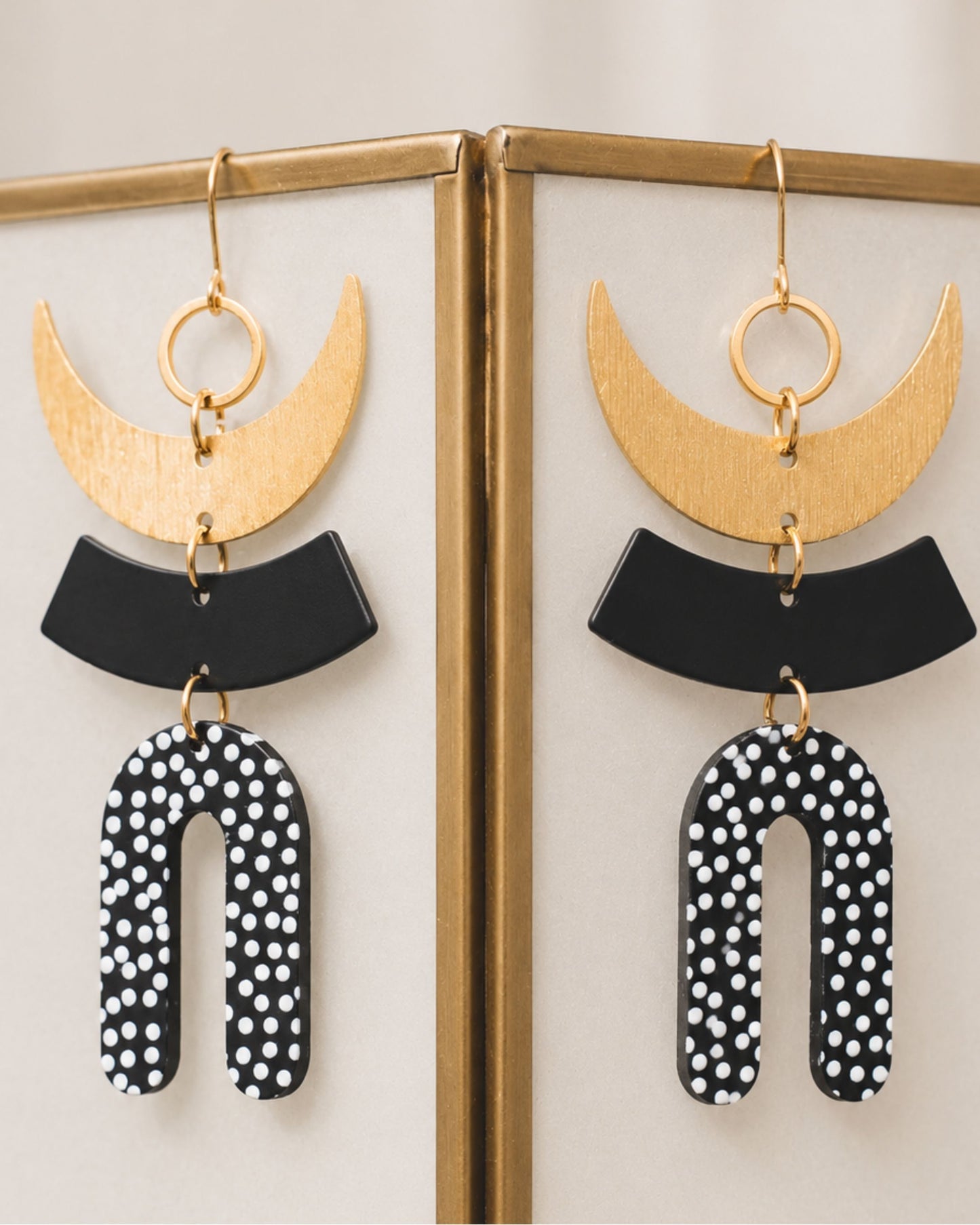 Side view of The Liv black-and-white polka dot and gold statement earrings — Olivia Holland